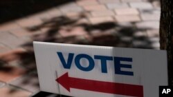 FILE - A "VOTE" sign stands outside an early voting location, Oct. 31, 2022, in Miami. U.S. officials charged with helping to secure the upcoming midterm elections fear the most dangerous and most likely threats may be difficult or impossible to detect in advance.