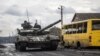 Ukrainian servicemen ride a tank in the village of Torske