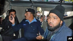 An intelligence official interrogating Mumtaz Qadri, Commando of Pakistan's Elite force, right, who allegedly killed Punjab's governor Salman Taseer, Islamabad, Jan 04 2011