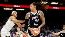 FILE - Phoenix Mercury center Brittney Griner (42) looks to pass as Chicago Sky center Candace Parker defends during the first half of game 1 of the WNBA basketball Finals, Oct. 10, 2021, in Phoenix. Griner was arrested in Russia last month.