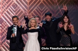 The cast of "Coda" accepts the award for outstanding performance by a cast in a motion picture and signs "I love you" at the 28th annual Screen Actors Guild Awards at the Barker Hangar, Feb. 27, 2022, in Santa Monica, California.
