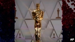 An Oscar statue sparkles in sunlight on the red carpet ahead of Sunday's 94th Academy Awards in the Hollywood section of Los Angeles, March 26, 2022. 