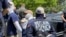 FILE - Authorities arrest members of the white supremacist group Patriot Front near an Idaho pride event, June 11, 2022, after they were found packed into the back of a U-Haul truck with riot gear.