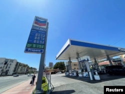 FILE - Gas prices over the $8.00 mark are advertised at a Chevron Station in Los Angeles, California, May 30, 2022.