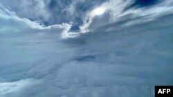 In this handout photo courtesy of the US Air Force a 53rd Weather Reconnaissance Squadron aircrew from Keesler Air Force Base, Missouri, flies a data collection mission into Hurricane Fiona over Bermuda on Sept. 22, 2022.