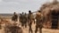 FILE - A photo taken June 10, 2016, and released by the African Union Mission in Somalia (AMISOM) shows soldiers on foot patrol in a village in Hiran region. Somalia's military said Sept. 12, 2022, that an offensive in the area has retaken 20 villages from al-Shabab fighters.