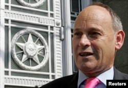 FILE - Then-British Ambassador Tony Brenton speaks to journalists outside the Russian Foreign Ministry in Moscow, July 19, 2007.