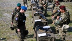 Servicemen from Poland inspect the weapons of Ukrainian paratroopers during a large military exercise called "Three Swords-2021" involving more than 1,200 servicemen and more than 200 combat vehicles from Ukraine, U.S., Poland and Lithuania, at Yavoriv training ground in Lviv region, Ukraine, July 27, 2021.