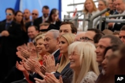 FILE - Israeli Prime Minister Benjamin Netanyahu, front row center; his wife, Sara Netanyahu, to his right; senior White House adviser Jared Kushner and his wife and the U.S. president's daughter, Ivanka Trump, seated to the prime minister's left; and U.S. Treasury Secretary Steve Mnuchin, at top right, attend the opening ceremony of the new U.S. Embassy in Jerusalem, May 14, 2018.