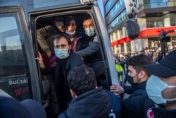 Turkish police officers detain protesters during a rally in support of Bogazici University students protesting the appointment of Melih Bulu, a ruling Justice and Development Party loyalist, as rector of the university, in Istanbul, Feb. 4, 2021.