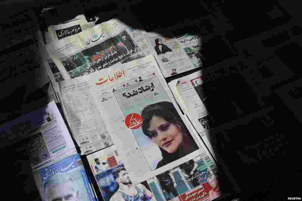 A newspaper with a cover picture of Mahsa Amini, a woman who died after being arrested by the Islamic republic's "morality police" is seen in Tehran, Iran, Sept. 18, 2022.