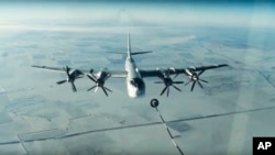 FILE - A Tu-95 strategic Russian bomber is in flight over Syria, from footage taken from the Russian Defense Ministry official website, Nov. 17, 2016. 