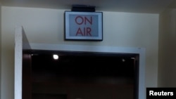 FILE - House Speaker Nancy Pelosi, her face partially covered to protect against the coronavirus, leaves after a news conference at the U.S. Capitol in Washington, April 21, 2020.
