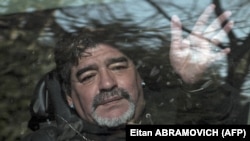 Mantan bintang sepak bola Argentina Diego Armando Maradona melambai kepada pendukungnya saat meninggalkan pemakaman ayahnya "Don Diego", di Bella Vista, pinggiran Buenos Aires. (Foto: AFP)