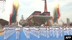 FILE — This screen grab made from video released by Chinese state broadcaster CCTV shows the launch ceremony of the Fujian, a People's Liberation Army aircraft carrier, at a shipyard in Shanghai, June 17, 2022.