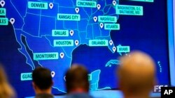 People wait and watch before FIFA announces the 2026 World Cup host cities, June 16, 2022, in Atlanta.