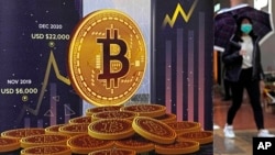 In this file photo, an advertisement for Bitcoin cryptocurrency is displayed on a street in Hong Kong on Feb. 17, 2022. (AP Photo/Kin Cheung, File)