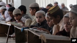 Pakistani children attend lessons at a madrassa, or a religious school, to learn Quran, in Karachi, Sept. 2, 2015. 