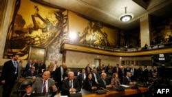 FILE - Members of the opposition Syrian Negotiations Commission attend the first meeting of the new Syrian Constitutional Committee at the United Nations in Geneva, Oct. 30, 2019. 