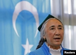 FILE - Uyghur leader Rebiya Kadeer delivers a speech in front of an East Turkestan flag at the fourth General Assembly of the World Uyghur Congress in Tokyo, May 14, 2012.