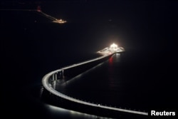 An evening view of the Hong Kong-Zhuhai-Macau bridge and its entrances to a cross sea tunnel, off Lantau island in Hong Kong, China October 21, 2018, before its opening ceremony on October 23, 2018.