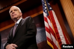 FILE - Senator John McCain looks on during a press conference.