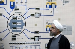 FILE - A handout picture released by the official website of the Iranian President Hassan Rouhani shows him visiting the control room of the Bushehr nuclear power plant in the Gulf port city of Bushehr, Jan. 13, 2015.