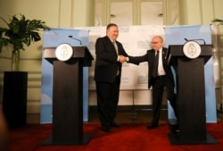 U.S. Secretary of State Mike Pompeo, left, and Argentine Foreign Minister Jorge Faurie, shakes hands during a press conference at an international counterterrorism conference in Buenos Aires, Argentina, Friday, July 19, 2019.