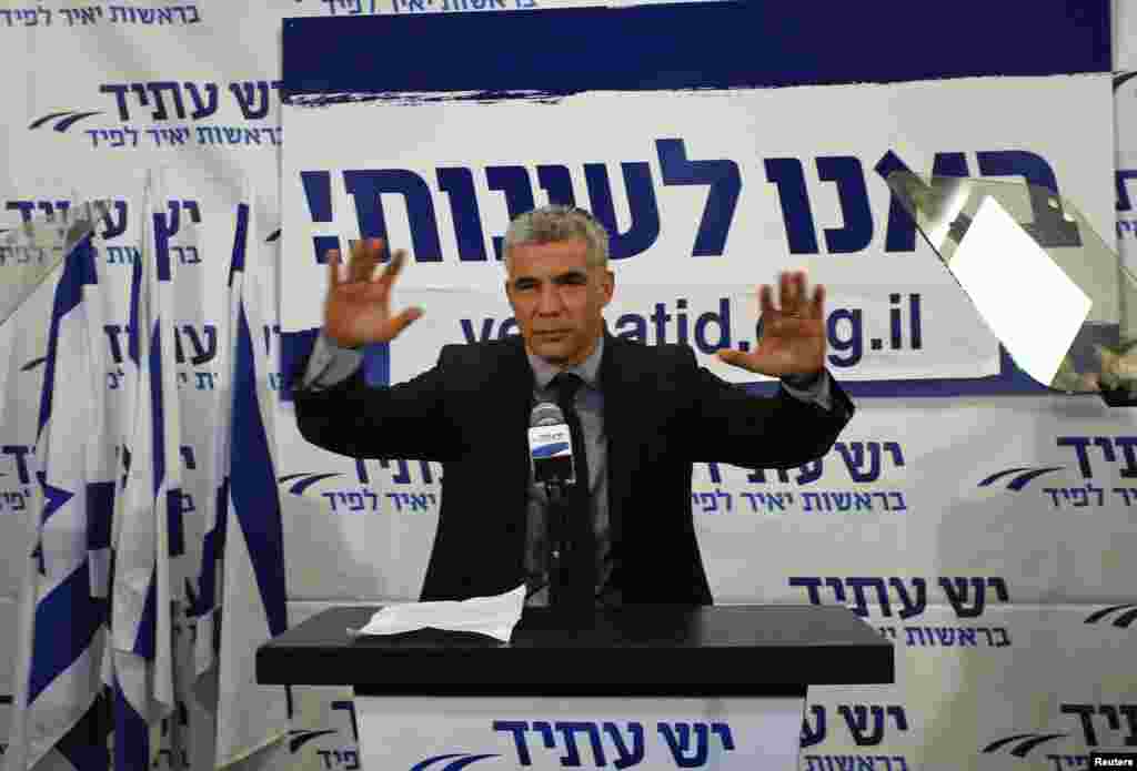 Yair Lapid, leader of the Yesh Atid (There is a Future) party, gestures in front of supporters at his party's headquarters in Tel Aviv, Israel, January 23, 2013.