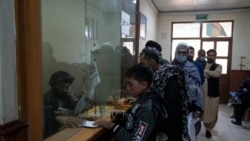 Taliban authorities check passports at the Afghanistan-Iran border crossing of Islam Qala, on Nov. 24, 2021.