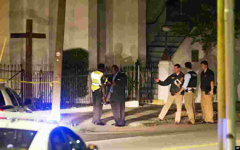 Police stand outside the Emanuel AME Church following a shooting Wednesday, June 17, 2015.