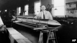Robert H. Goddard is shown June 8, 1938 at Roswell, New Mexico, with one of the rockets he developed from 1926 to 1941. (AP Photo)