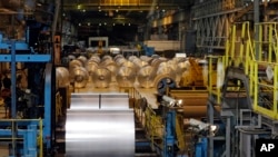 FILE - Finished galvanized steel coils are seen in the hot dip galvanizing line at ArcelorMittal Steel in Cuyahoga Heights, Ohio, Feb. 15, 2013. Brazil and Argentina are among the countries from which the U.S imports its metals.