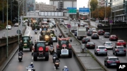 Farmer drive their tractors on the Paris ring road in Paris, France, Nov. 27, 2019.