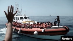 Migrants are seen after being rescued by Aquarius, a ship run in partnership between SOS Mediterranee and international aid group Doctors Without Borders, in the central Mediterranean Sea, June 12, 2018. 