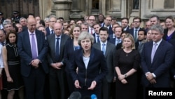 Theresa May speaks to reporters after being confirmed as the leader of the Conservative Party and Britain's next Prime Minister outside the Houses of Parliament in Westminster, central London, July 11, 2016. (REUTERS/Neil Hall)