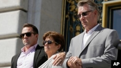 FILE - From left, Brad Steinle, Liz Sullivan and Jim Steinle, the brother, mother and father of Kate Steinle, who was shot to death on a pier, listen to a news conference on the steps of City Hall in San Francisco, Sept. 1, 2015. Steinle's parents are su