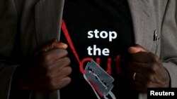 FILE - A man's T-shirt reads "Stop the Cut," referring to female genital cutting or mutilation, during a social event advocating against the practice at the Imbirikani Girls High School in Imbirikani, Kenya, April 21, 2016.