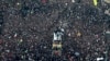 Coffins of Gen. Qassem Soleimani and others who were killed in Iraq by a U.S. drone strike, are carried on a truck surrounded by mourners during a funeral procession, in the city of Mashhad, Iran, Jan. 5, 2020.