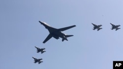 FILE - A U.S. B-1 bomber, center, flies over Osan Air Base with U.S. jets in Pyeongtaek, South Korea, Tuesday, Sept. 13, 2016.