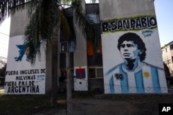 Sebuah mural dengan gambar Diego Maradona dan Kepulauan Malvinas di lingkungan San Pablo, Buenos Aires, 23 Mei 2022. (AP Photo/Rodrigo Abd)