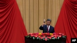 Chinese President Xi Jinping makes a toast on stage after delivering his speech at a dinner marking the 75th anniversary of the founding of the People's Republic of China, at the Great Hall of the People in Beijing, Sept. 30, 2024.