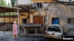 A woman walks at a site of a recent shelling, which local Russian-installed authorities called a Ukrainian military strike, in the course of Russia-Ukraine conflict in Donetsk, Russian-controlled Ukraine, July 22, 2024. 