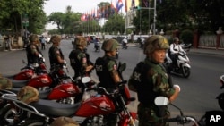 FILE: Riot police block a street near the Supreme Court in Phnom Penh, Cambodia, Tuesday, Oct. 31, 2017. The Supreme Court on Tuesday uphold the lower court's decision to continue to detain opposition leader Kem Sokha who has been charged with treason, the latest in a series of moves to gain an advantage ahead of 2018 general election. (AP Photo/Heng Sinith)