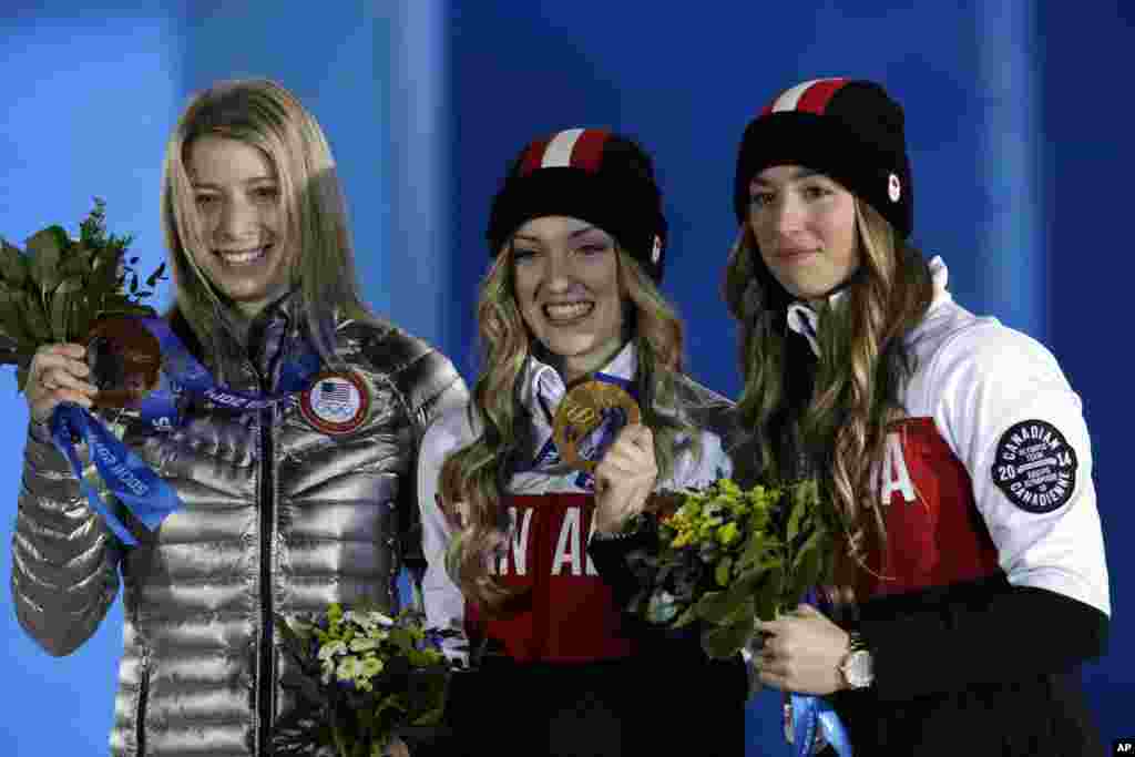 Women's mogul medalists from left, Hannah Kearney of the United States, bronze, Canada's Justine Dufour-Lapointe, gold, and her sister silver medalist Chloe Dufour-Lapointe pose during their medal ceremony at the 2014 Winter Olympics, Sochi, Russia, Feb. 9, 2014.