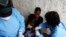 FILE - A South Sudanese girl suffering from cholera is being treated by medics in Juba Teaching Hospital in Juba, May 27, 2014. More than 1.1 million doses of oral cholera vaccine arrived in Juba, and will be dispatched next week to hot spots areas like the town of Bentiu.