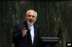 FILE - Iranian Foreign Minister Mohammad Javad Zarif, who is also Iran's top nuclear negotiator, addresses an open session of parliament in Tehran.