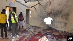 People inspect a damaged mosque following an explosion in Maiduguri, Nigeria, Oct. 23, 2015. Boko Haram is suspected to be behind bombing.