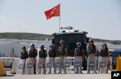 FILE - Turkish police officers secure the entrance of Istanbul new airport construction site in Istanbul, Sept.15, 2018.