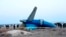 FILE - In this photo taken from a video released by the administration of Mangystau region, a part of Azerbaijan Airlines' Embraer 190 lies on the ground near the airport of Aktau, Kazakhstan, Dec. 26, 2024.